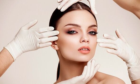 Hand in gloves on girl's face